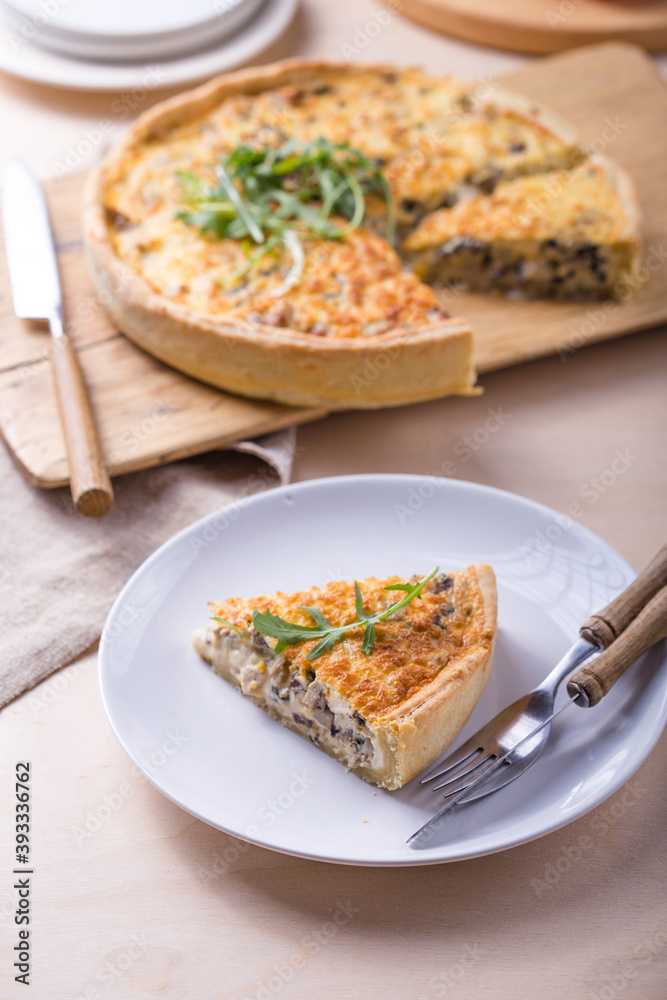 Traditional French Quiche with cheese, spinach and chicken. Quiche lorraine. French cuisine. Top view. Light wooden background