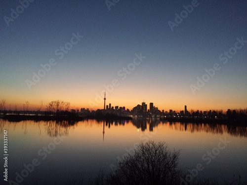 Toronto supercity during the sunset. Appears as a silhouette in background. © Paschalis