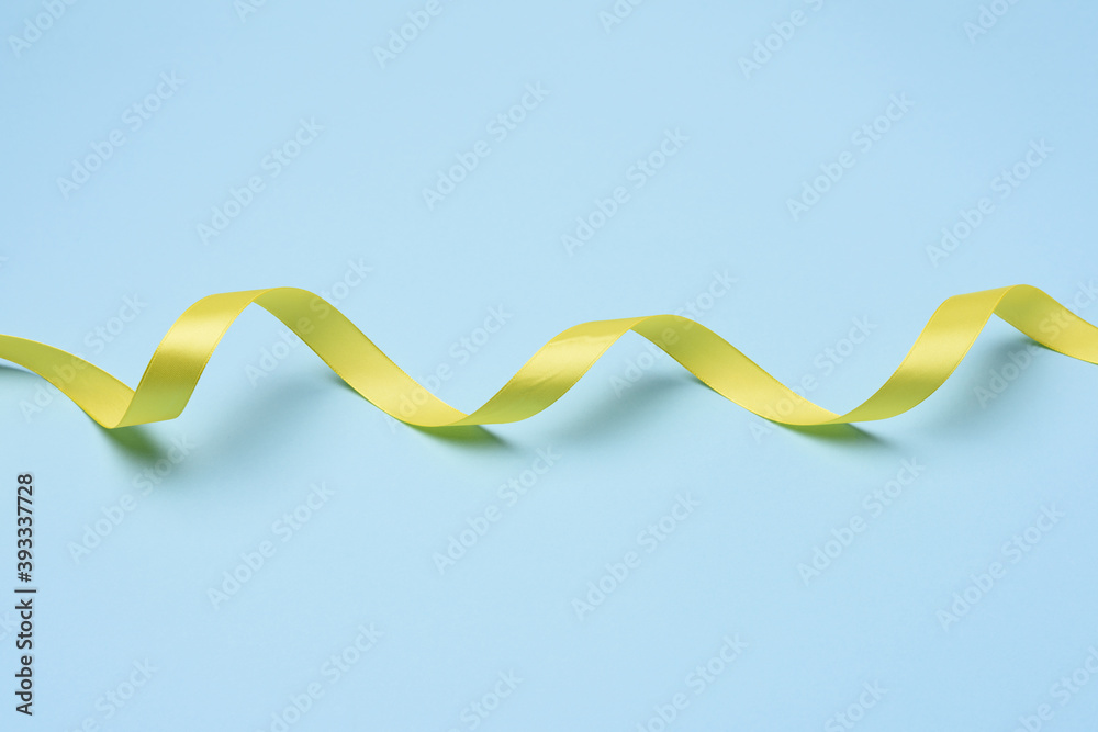 twisted yellow ribbons on a blue background twisted yellow ribbons on a blue background