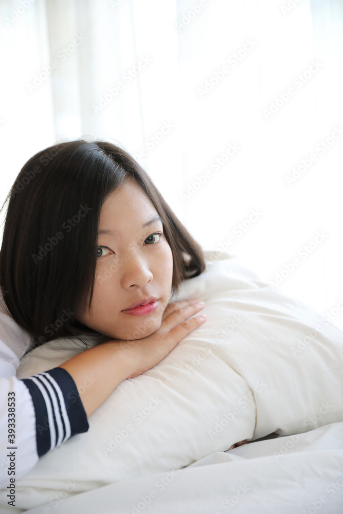 school girl sleeping on bed in white tone bedroom school girl sleeping on bed in white tone bedroom