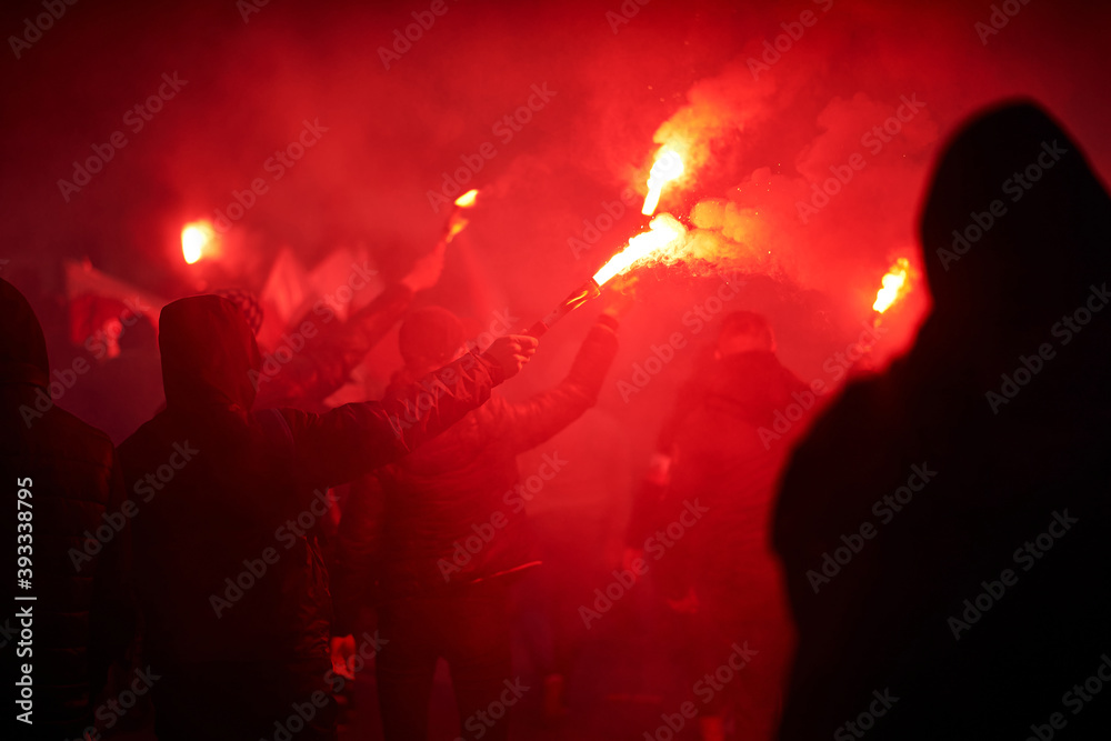 flaming red flare during a street protest in the city