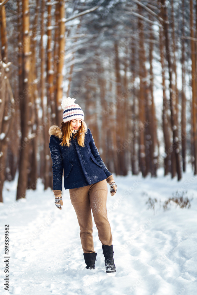 Portrait of Beautiful woman enjoys winter, frosty day. Fashion young woman in the snow forest. Winter holidays. Portrait of Beautiful woman enjoys winter, frosty day. Fashion young woman in the snow forest. Winter holidays.