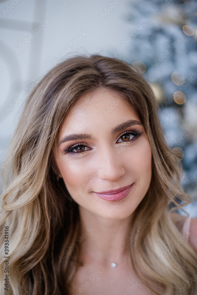 A close up portrait of the pink lips of a beautiful blonde girl with a clean face, without problem-free skin and professional nude makeup. Shining smile with white teeth. Photo without retouching