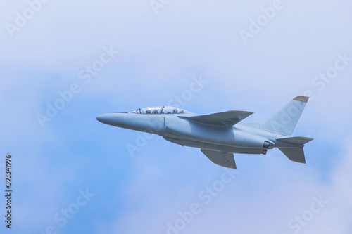 airplane(fighter) flying in blue sky with bright light tone