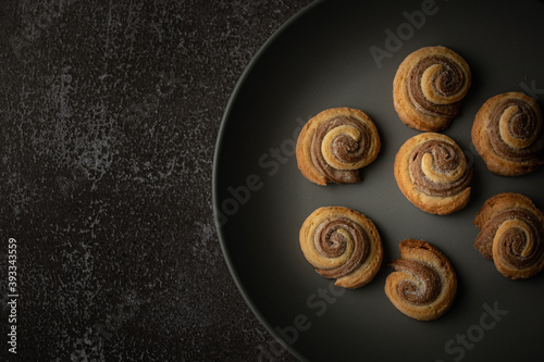 Still life with baked double-layered spiral cookies on plate