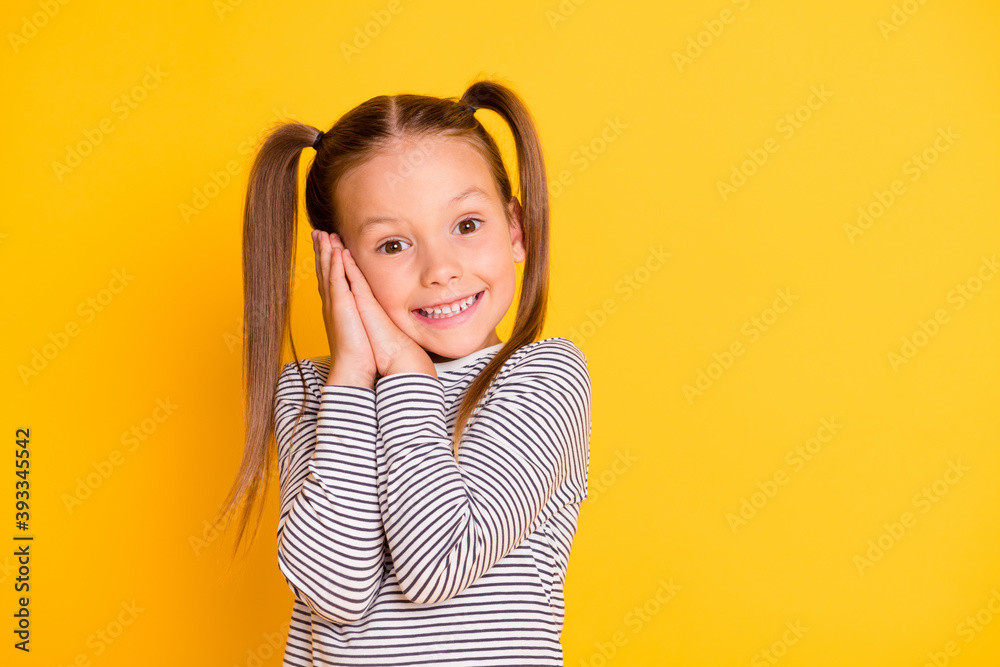 Portrait of young dreamy happy smiling girl child kid just wake-up isolated on yellow color background