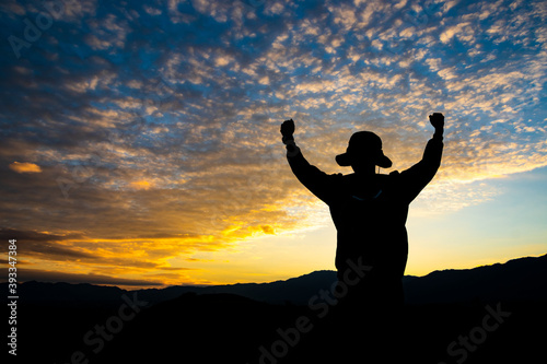 Man with arms extended toward heaven at sunrise ,success or prayer concept © Konkhay