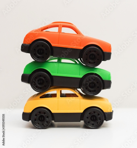 Close up stack of three colorful toy cars made from recyclable non toxic safe plastic, zero waste, reuse and recycle concept 
