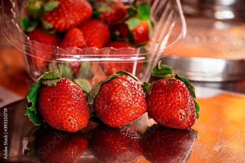 Picture of 3 strawberries with background of strawberries too. Strawberry picture.