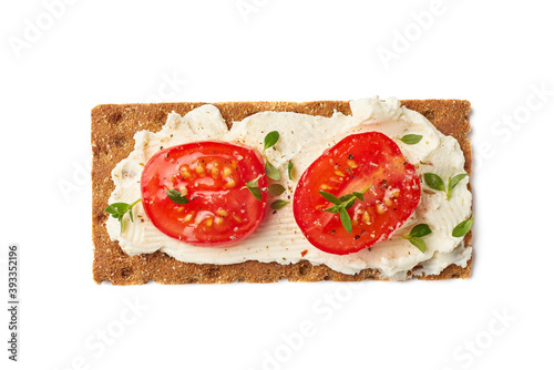 Bild auf Leinwand Crispbread with cream cheese and tomato slices on white