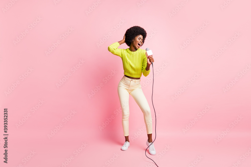 Full body photo of attractive person hand on head sing dance have fun green sweater isolated on pink color background Full body photo of attractive person hand on head sing dance have fun green sweater isolated on pink color background