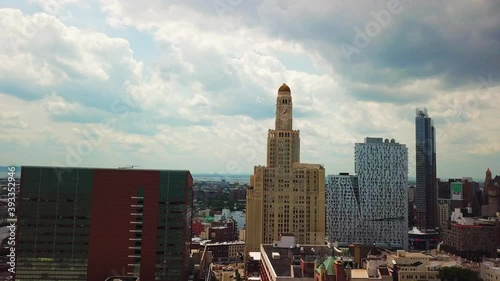 Approaching Old Skyscraper with a Large Time Clock photo