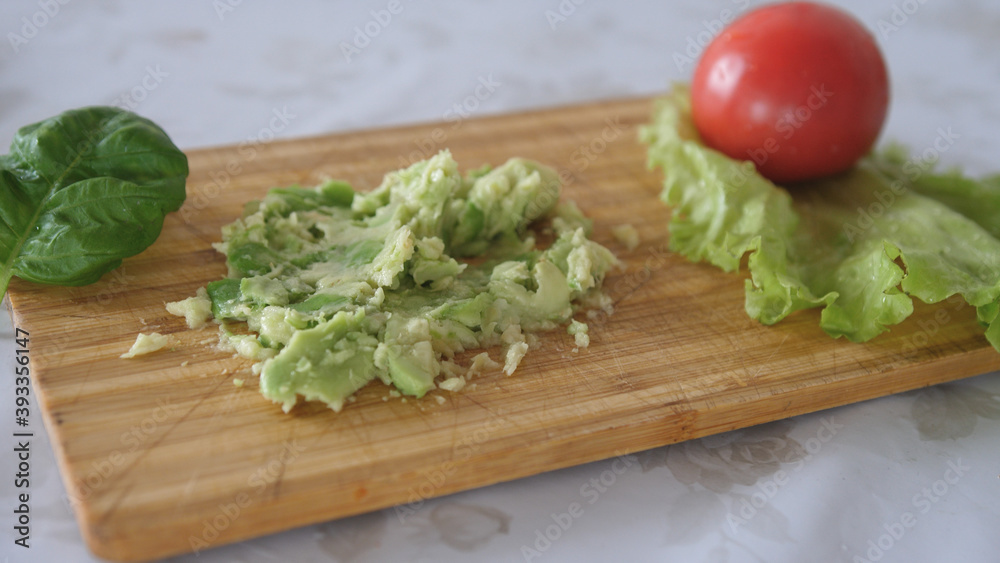 mashing avocado on a board. Cooking healthy food mashing avocado on a board. Cooking healthy food