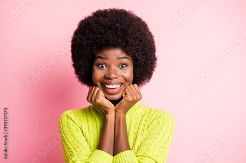 Photo portrait of adorable girl holding face chin with two hands isolated on pastel pink colored background