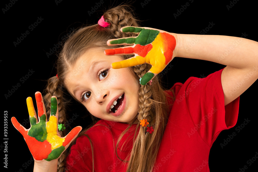 A girl in a red t-shirt on a black background smeared with paint. A girl in a red t-shirt on a black background smeared with paint.