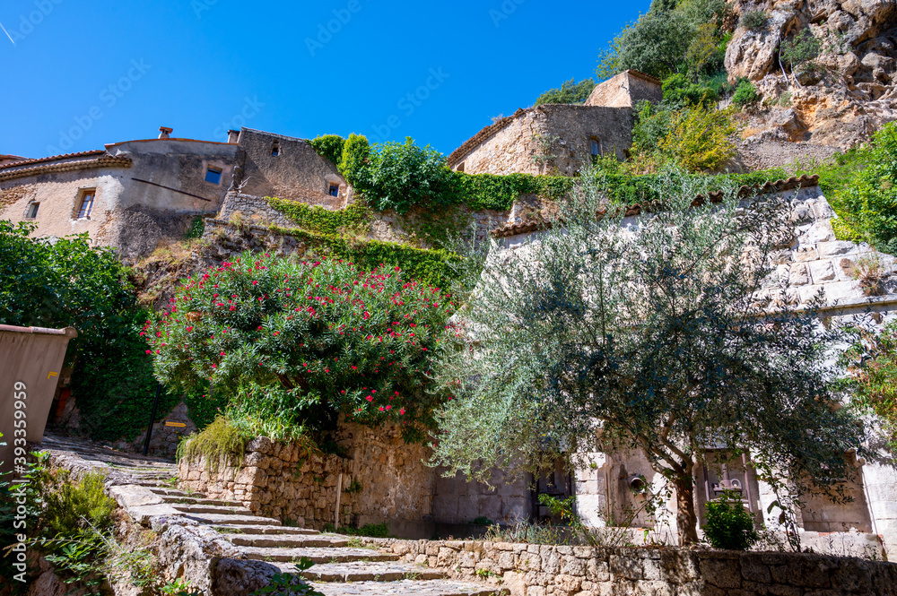 Travel destination, small ancient village Cotignac in Provence, surrounded by vineyards and cliffs with troglodytes houses. Travel destination, small ancient village Cotignac in Provence, surrounded by vineyards and cliffs with troglodytes houses.