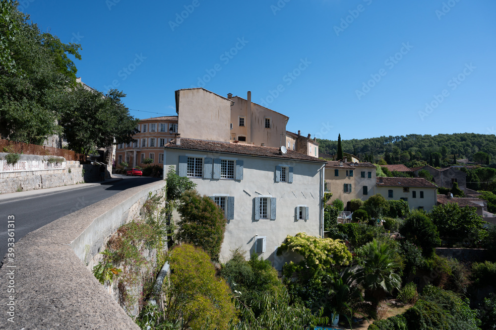 Travel destination, small ancient village Cotignac in Provence, surrounded by vineyards and cliffs with troglodytes houses.