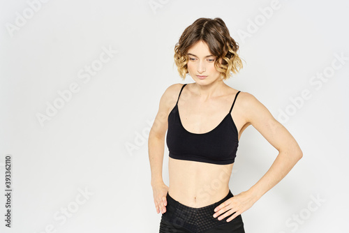 Slender woman in leggings on a light background doing fitness gymnastics exercises © SHOTPRIME STUDIO