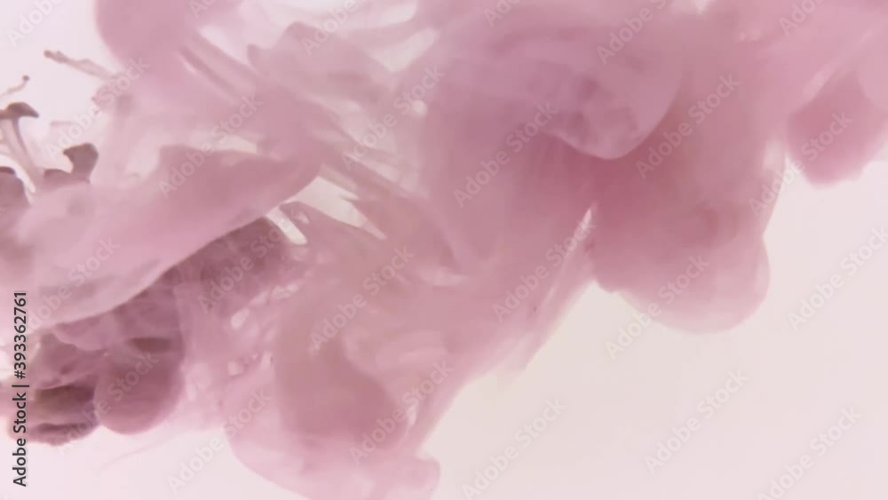 Pink watercolor ink in water on a white background. Video of how ink dissolves in clear water on a white background, pink smoke evaporates, penetration of a different color, beautiful video clip