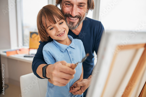 Happy dad and his son having arts and crafts time