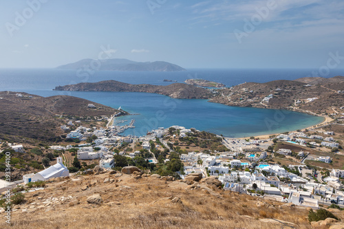 View of the white buildings of Chora and port, Ios island, Greece.