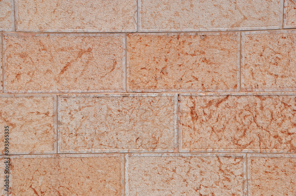 Naklejka premium Background, texture - a plastered wall with joining for large bricks. Pink color