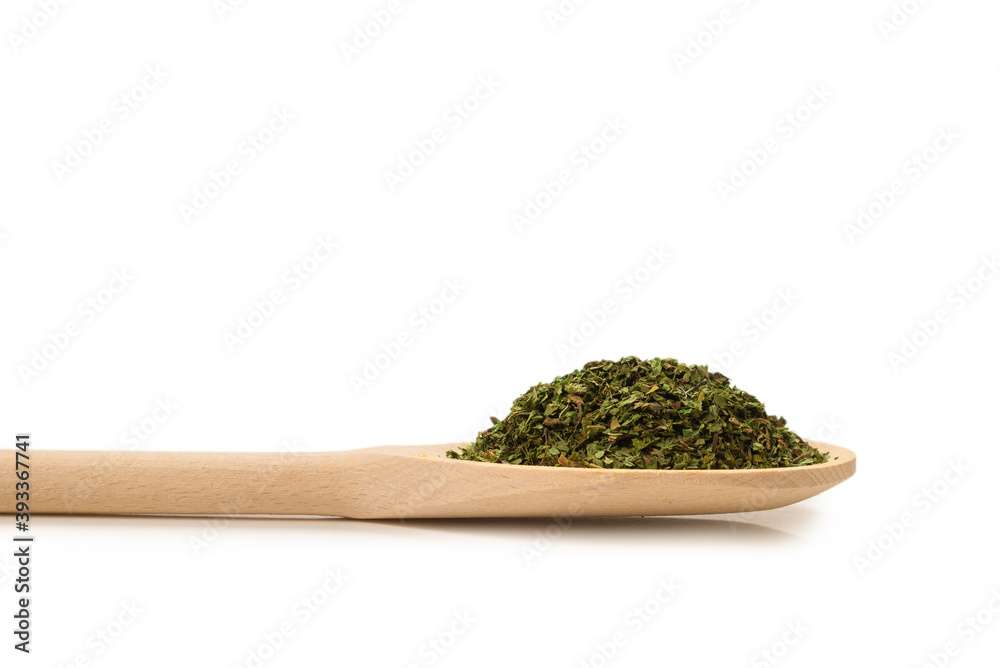 Dry mint in wooden spoon isolated on white. Dry mint in wooden spoon isolated on white.