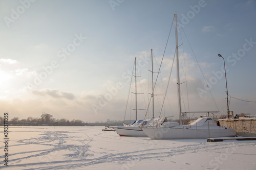 Winter landscape with a yacht on a frozen lake  © Oleh