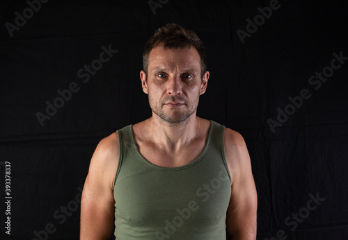 Very well built sexy male model in fashionable active sportwear against black background with copy space © coob.kz