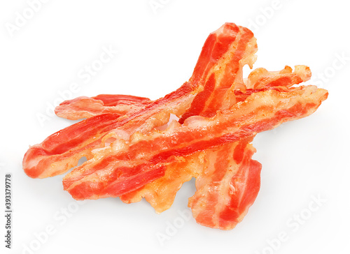 Strips of fried bacon closeup isolated on a white background.