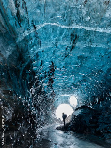 A man in an Ice Cave in Breiðarmerkurjökull Outlet Glacier, Vatnajökull National Park, Southeast Iceland.