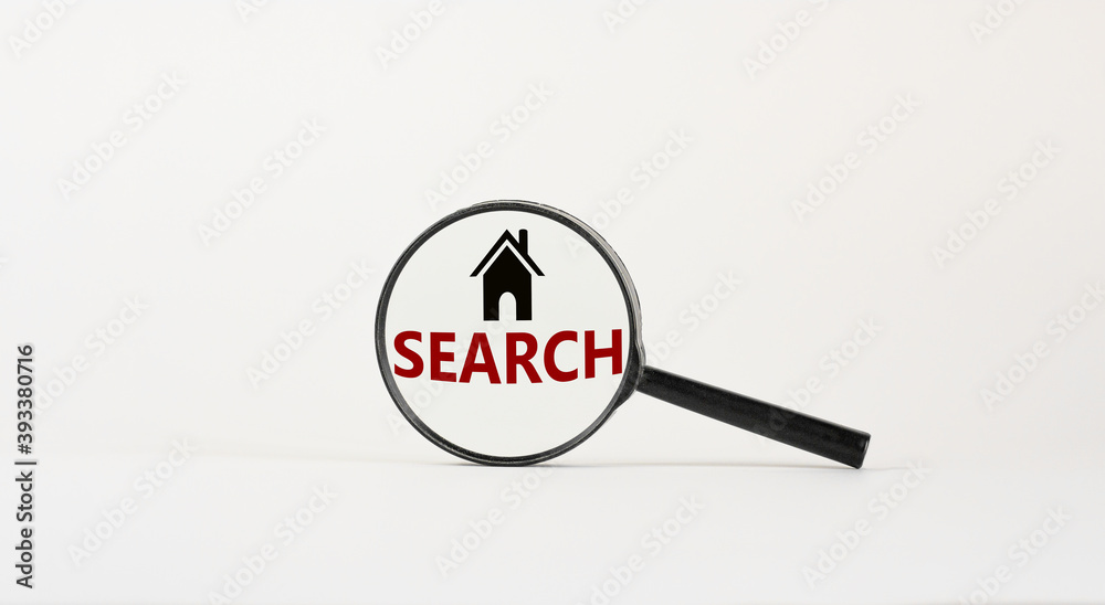 Magnifying glass with text 'search' and house icon on beautiful white background. Business concept, copy space. Magnifying glass with text 'search' and house icon on beautiful white background. Business concept, copy space.