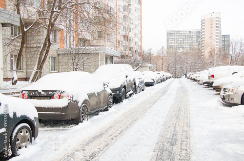 Fotografi Snow-covered cars in the city after a snowfall