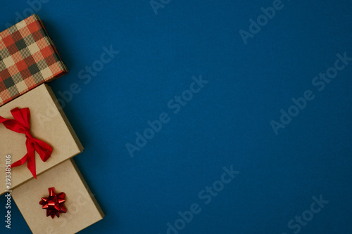 Gift boxes on a blue background. Christmas and New Year's decor. Copy space, mock up