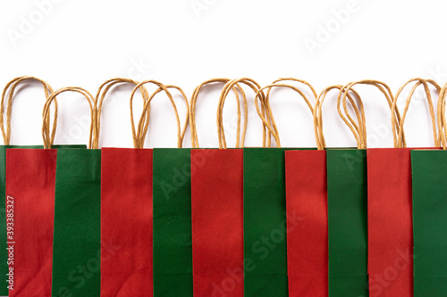 Colorful craft paper bags lie on a white background. Sale. Black Friday concept. Copy space