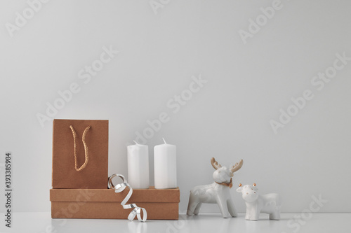 Porcelain figurine of a deer and a bull and New Year s  festive decor. Copy space  mock up.