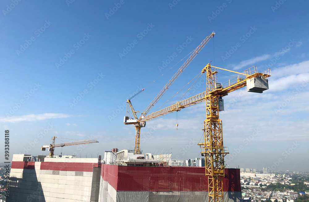 Crane and workers at construction site.