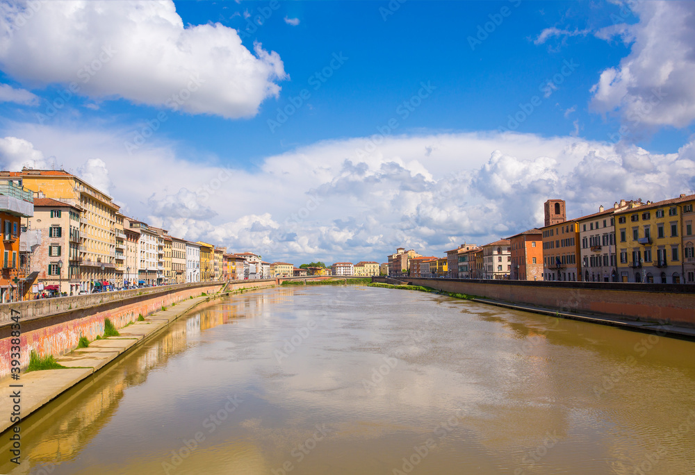 Colorful, old buildings on River Arno in Pisa, Italy
