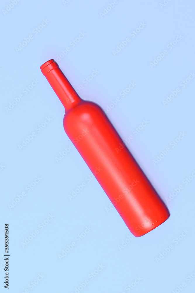 red glass bottle on blue background red glass bottle on blue background
