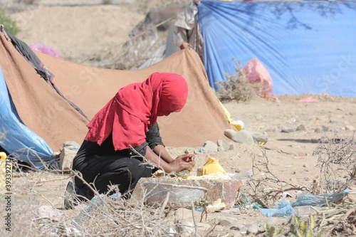 Yemeni woman makes food for her homeless children in displacement campsin the city of Taiz after the Houthi militia displaced them and drove them out Their homes