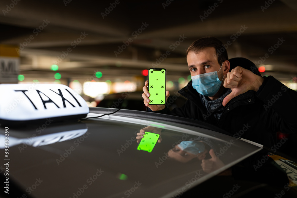 Young passenger showing something on his phone during coronavirus pandemic