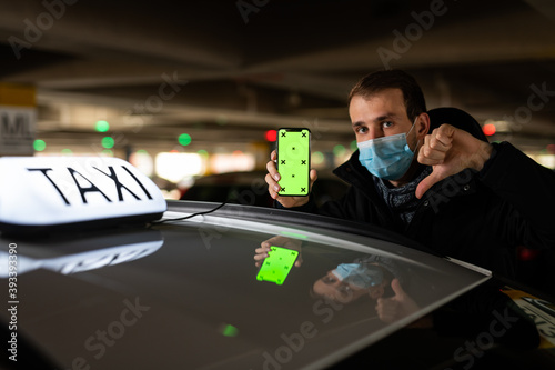 Obraz na płótnie Young passenger showing something on his phone during coronavirus pandemic w salonie