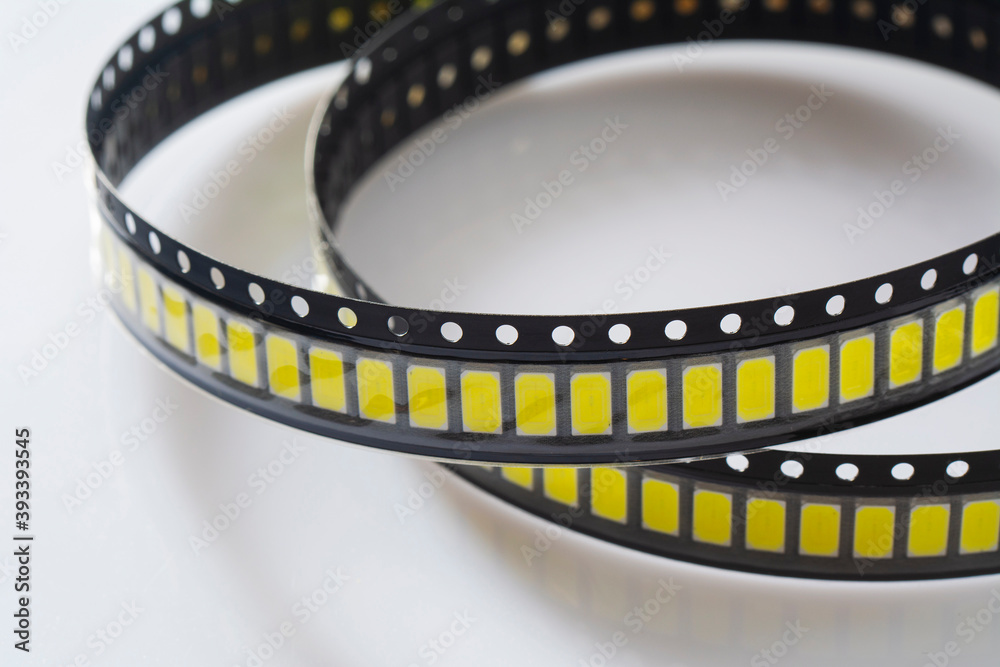 Yellow Led strip coil packaging closeup isolated on white background. Spare part for repair lamp or latern. Diode tape in the package.