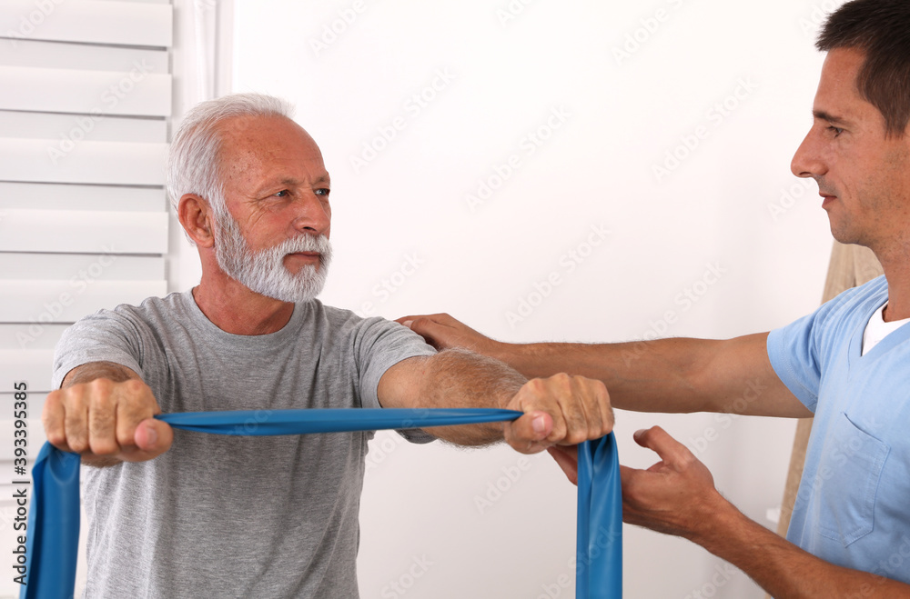 Obraz premium Physiotherapy, Injury rehabilitation of senior male patient. Kinesiology treatment