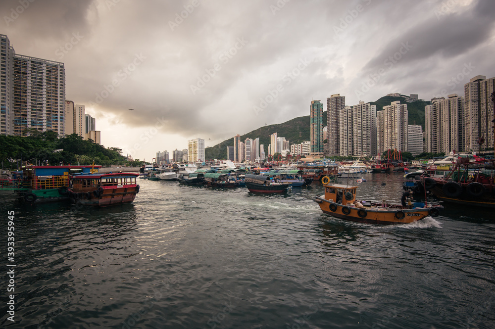 Obraz premium Aberdeen Harbour seen from Ap Lei Chau Bridge, In this area you will find fishing boats, houseboats, and sampans, The bay between the south coast of Hong Kong Island