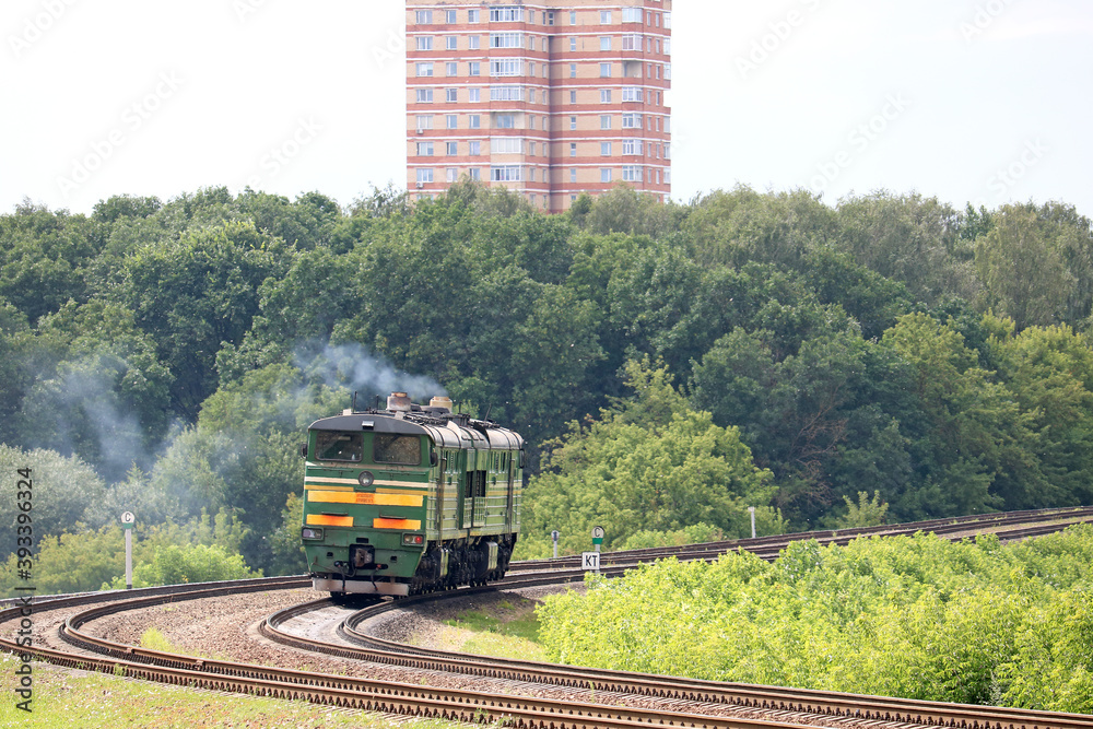 Naklejka premium powerful diesel locomotive in the city