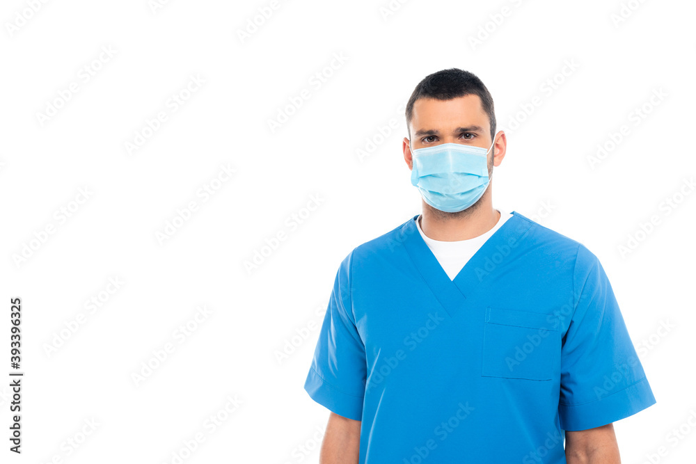 Nurse in medical mask and uniform looking at camera isolated on white Nurse in medical mask and uniform looking at camera isolated on white