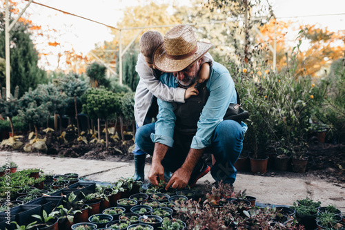 boy with his grandfather in family tree nursery