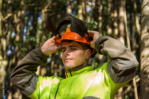 forest worker putting on helmet to work in the forest