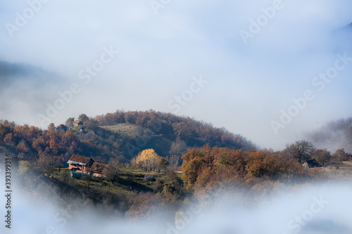 misty lonely mountain village surrounded with fog